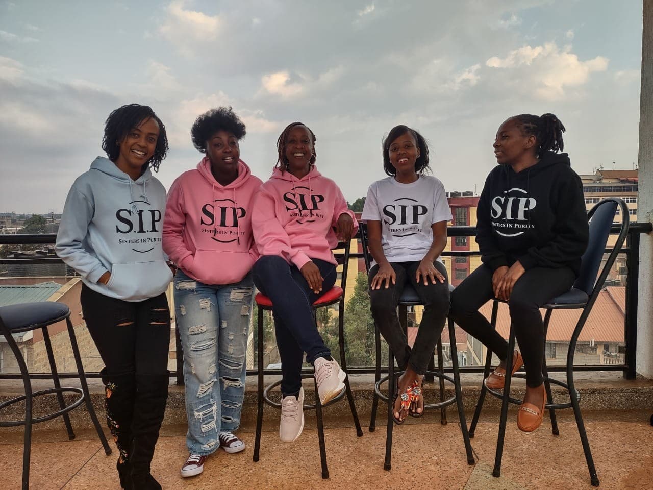 Five S.I.P members in their hoodies on a rooftop in Nairobi