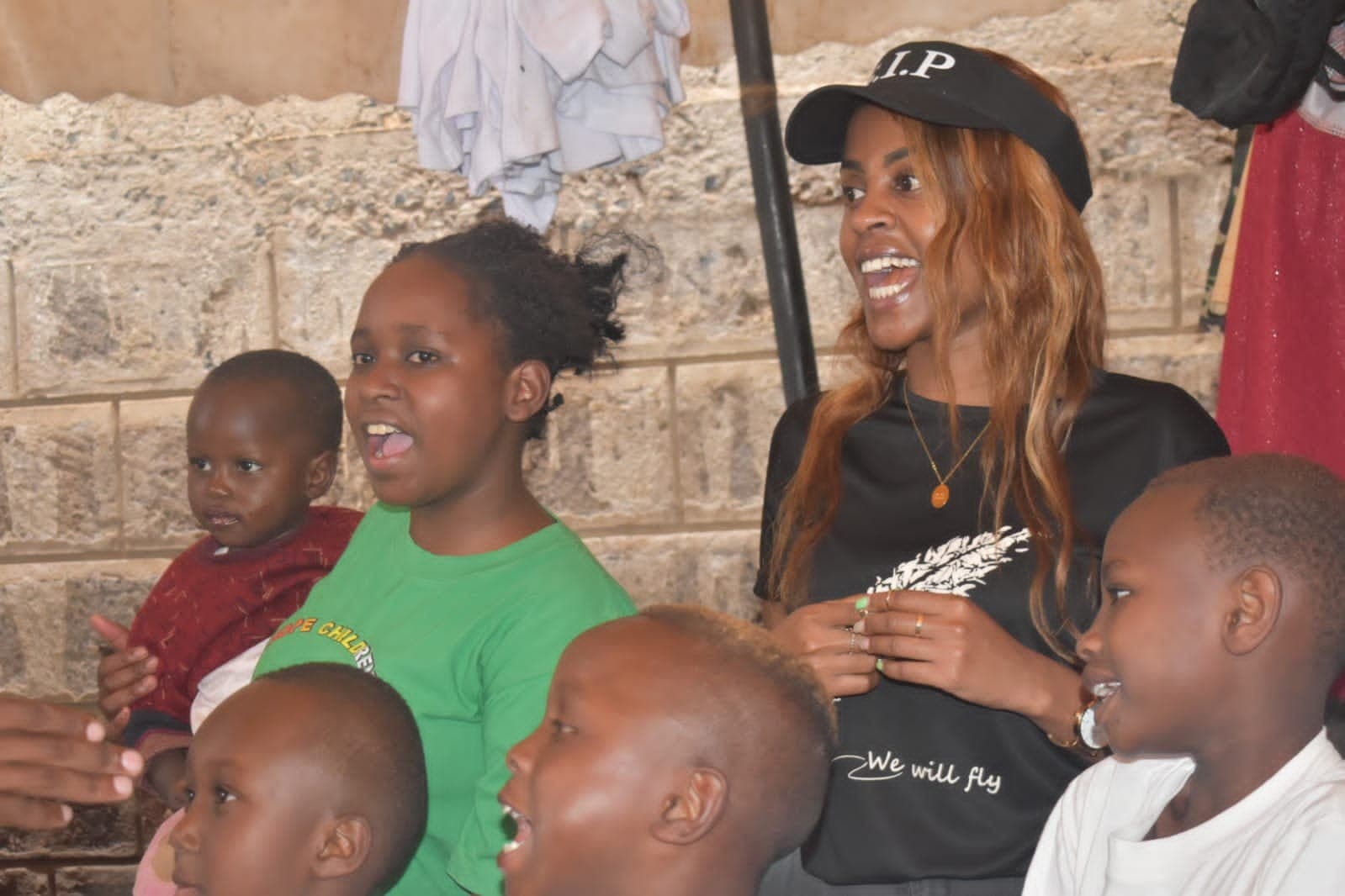 An S.I.P member singing and laughing with children during a visit to Great Hope Child Home